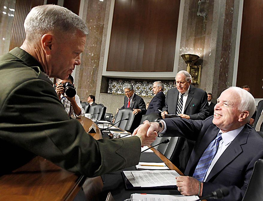 US Marines Gen. James F. Amos , left, shakes hands with the Senate Armed Services Committee ranking Republican Sen. John McCain, R-Ariz., on Capitol Hill in Washington, Tuesday, Sept. 21, 2010, prior to testifying before the committee's hearing on his nomination for reappointment to the grade of general and the be Commandant of the Marine Corps. Committee members, from left are, Sen. Daniel Akaka, D-Hawaii, Sen. Jack Reed, D-R.I., committee Chairman Sen. Carl Levin, D-Mich., and McCain. (AP Photo/Alex Brandon)
