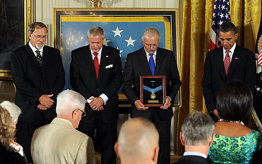 U.S. President Barack Obama stands with sons Steven Wilson and Cory and Richard Etchberger after Obama awarded Chief Master Sergeant Richard L. Etchberger, U.S. Air Force, the Medal of Honor for conspicuous gallantry in the East Room of the White House in Washington on September 21, 2010. Etchberger was killed in Laos in 1968 helping to save wounded men. UPI/Roger L. Wollenberg