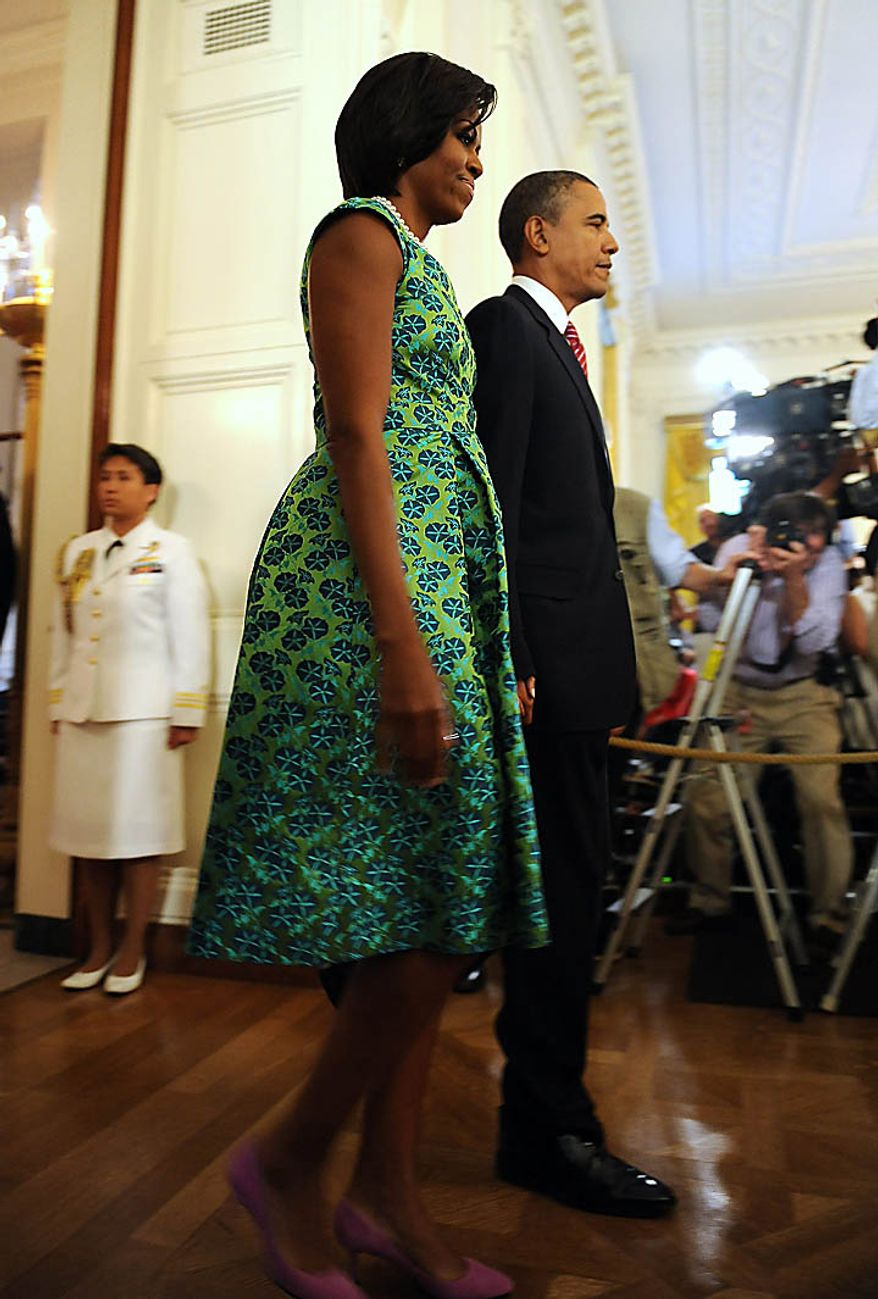 First Lady Michelle Obama and U.S. President Barack Obama arrive to award Chief Master Sergeant Richard L. Etchberger, U.S. Air Force, the Medal of Honor for conspicuous gallantry in the East Room of the White House in Washington on September 21, 2010. Etchberger was killed in Laos in 1968 helping to save wounded men. UPI/Roger L. Wollenberg