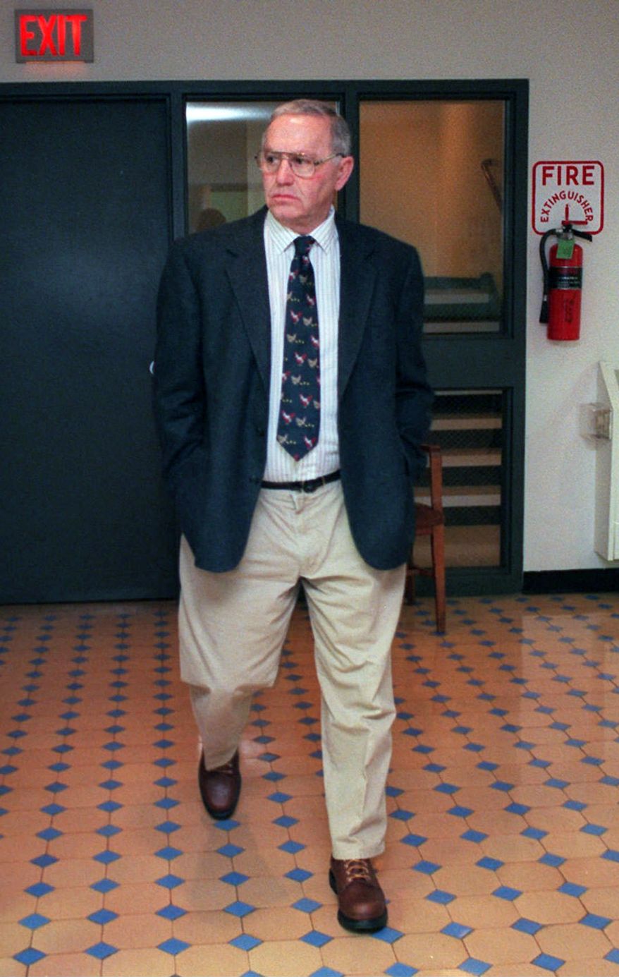 In this 1997 file photo Austin "Jack" DeCoster, owner of an Iowa egg farm, walks to the courtroom in the Wright County Court house to testify in defense of his family's hog confinement facilities. (AP Photo/Kevin Wolf, File)