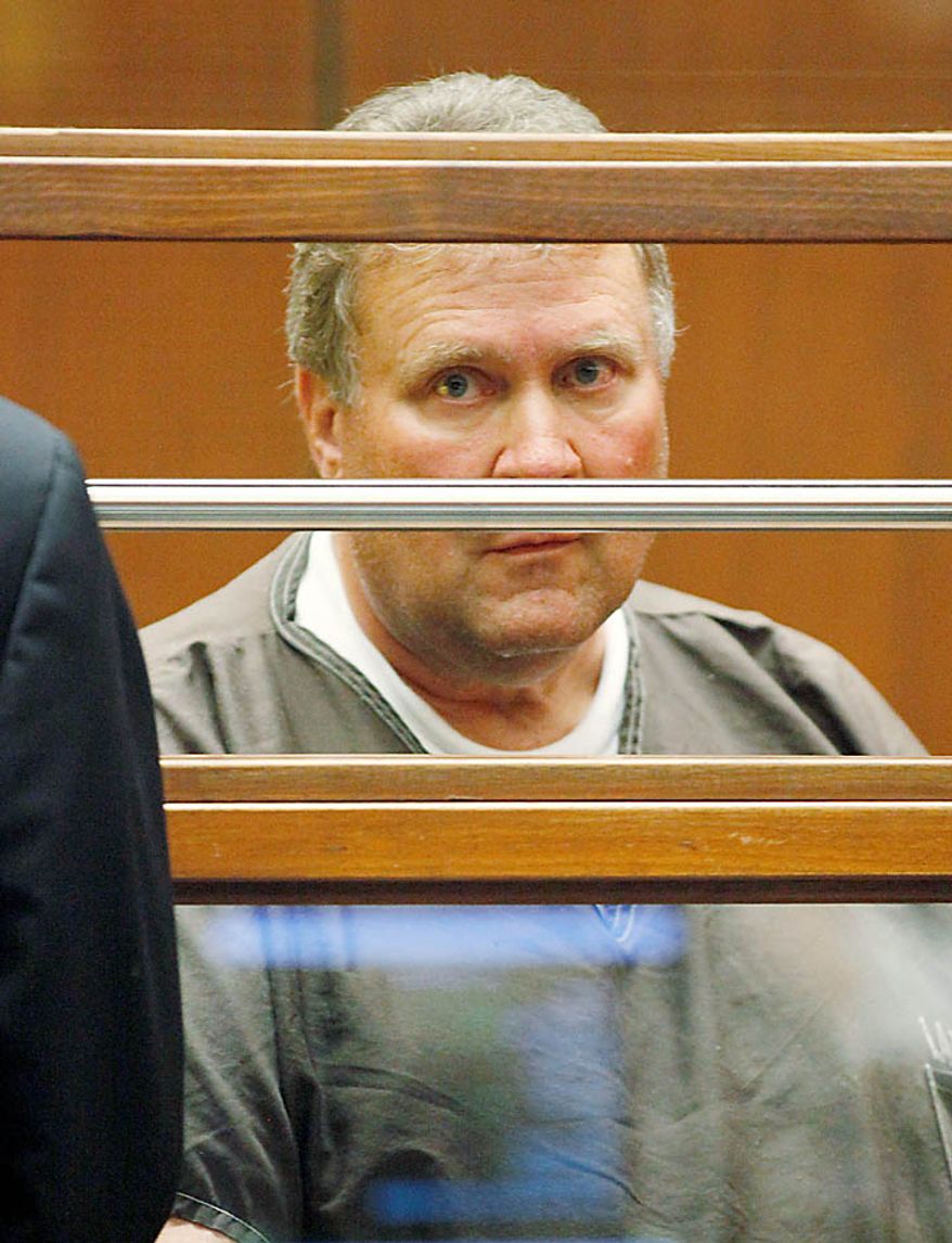 Former council member George Cole stands in the dock, among eight current and former Bell, Calif., city officials arrested on corruption charges, as they appear in court at the Criminal Justice Center in downtown Los Angeles Wednesday, Sept. 22, 2010. (AP Photo/Al Seib, Pool)