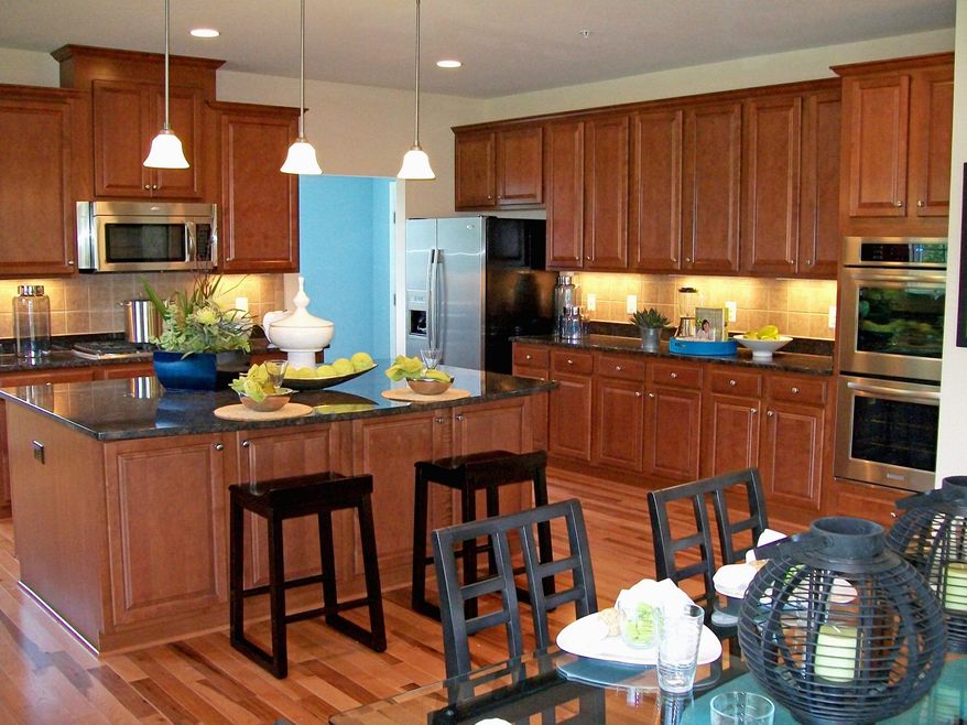 The center-island kitchen in the Colby model at the Woods at Myrtle Point has 42-inch cabinets and a breakfast area. The home is priced from $329,990.