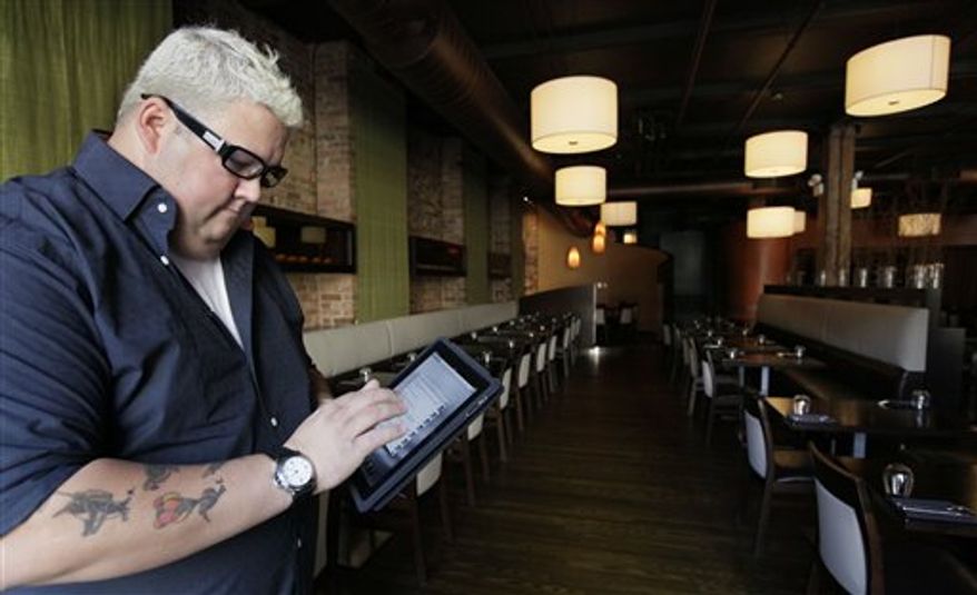 This Tuesday, Sept. 14, 2010 photo shows chef Graham Elliot of Graham Elliot restaurant as he poses in the dining room of his restaurant in Chicago. Elliot frequently tweets his opinions about topics other than his restaurant or cooking, from current events to fantasy football picks. He even uses Twitter to let his followers make decisions about the music the restaurant plays. (AP Photo/M. Spencer Green)
