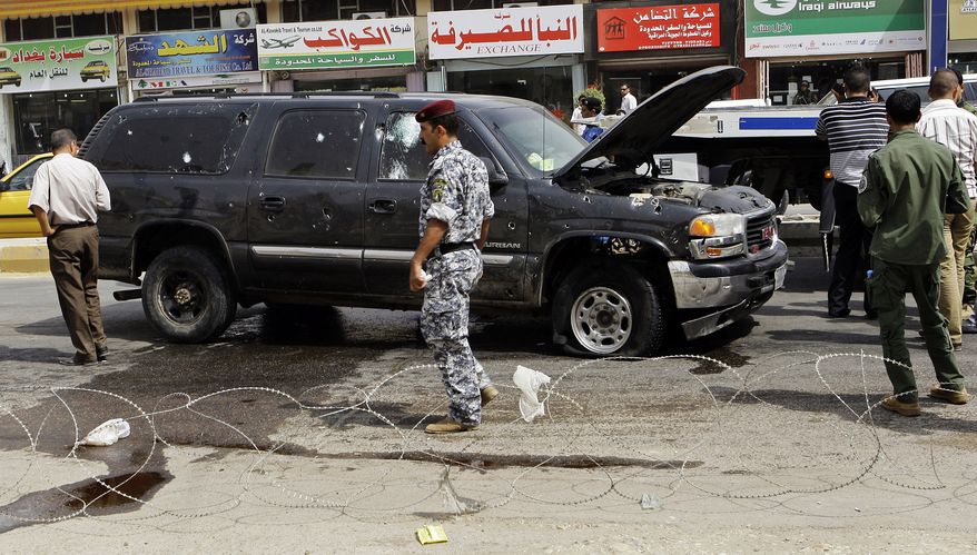 Iraqi security forces inspect the scene of a roadside bomb in central Baghdad on Sunday, Sept. 26, 2010. The blast killed a passer-by and wounded several others in the mixed Sunni-Shi'ite Karradah neighborhood. Officials said the bomb appeared to be targeting a police patrol. (AP Photo/Hadi Mizban)