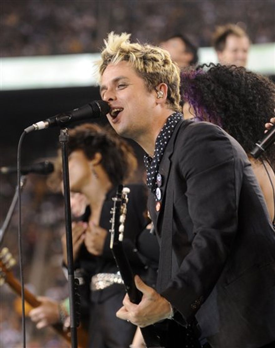 FILE - In this Sept. 13, 2010 file photo, Billie Joe Armstrong of Green Day performs with cast members of the Broadway musical &quot;American Idiot&quot; at halftime during an NFL football game between the New York Jets and the Baltimore Ravens at New Meadowlands Stadium in East Rutherford, N.J. Green Day front man Billie Joe Armstrong is joining the cast of &quot;American Idiot,&quot; the Broadway show he helped create based on the band&#x27;s 2004 Grammy-winning album, The Associated Press reported Sunday, Sept. 26, 2010. (AP Photo/Henny Ray Abrams, File)