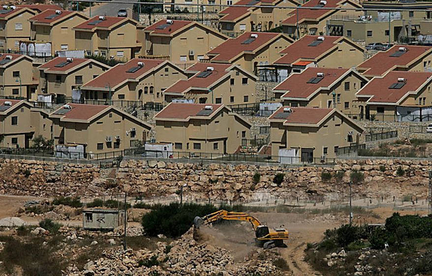 Israeli earth-moving equipment works in the Jewish settlement of Kiryat Netafim, near the West Bank village of Salfit, Monday, Sept. 27, 2010. Senior Palestinian official Yasser Abed Rabbo said Monday that President Mahmoud Abbas remains ready to walk out on Mideast peace talks if Israel resumes construction in its West Bank settlements now that building restrictions have expired. (AP Photo/Nasser Ishtayeh)