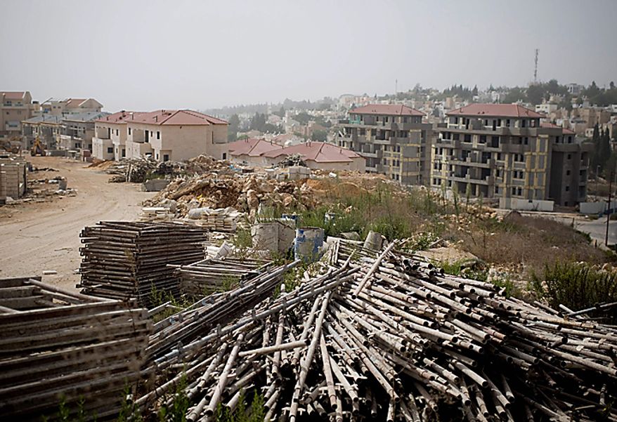 Piles of building materials are placed on the ground at a construction site for a housing project in the West Bank Jewish settlement of Ariel, Sunday, Sept. 26, 2010. Israelis, Palestinians and U.S. mediators were racing Sunday to find a compromise that would allow the fragile new Mideast talks to continue after an Israeli settlement slowdown expires at midnight. (AP Photo/Ariel Schalit)