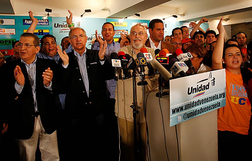 Opposition members celebrate after National Electoral Council announced results of congressional elections in Caracas, Venezuela, Monday , Sept 27, 2010. President Hugo Chavez held on to a congressional majority in elections Sunday, but his opponents made gains that could help them challenge his grip on power. (AP Photo/Leonardo Ramirez)