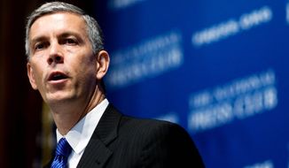 ** FILE ** Education Secretary Arne Duncan visited Friendship Collegiate Academy in Northeast on Wednesday to tout the federally funded Gaining Early Awareness and Readiness for Undergraduate Programs. (Associated Press)