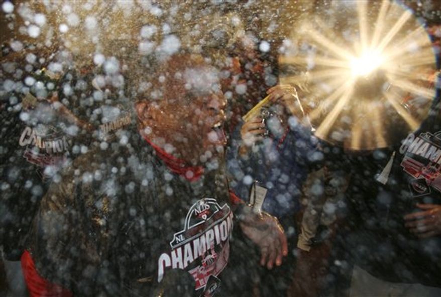 Cincinnati Reds manager Dusty Baker is sprayed with champagne after the Reds defeated the Houston Astros 3-2 in a baseball game to clinch the NL Central, Tuesday, Sept. 28, 2010, in Cincinnati. (AP Photo/Tom Uhlman)