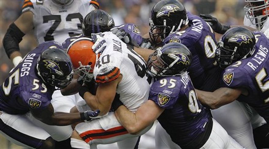 Cleveland Browns running back Peyton Hillis is stopped by Baltimore Ravens linebacker Terrell Suggs, linebacker Jarret Johnson, defensive tackle Haloti Ngata and linebacker Ray Lewis during the second half of an NFL football game in Baltimore, on Sunday, Sept. 26, 2010. (AP Photo/Evan Vucci)
