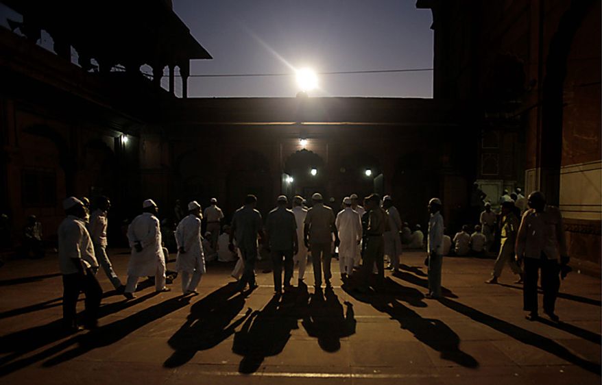 Indian Muslims leave after offering prayers after the Ayodhya verdict in the old city area of New Delhi, India, Thursday, Sept. 30, 2010. An Indian court ruled Thursday that a disputed holy site that sparked bloody riots in the past should now be divided between the Hindu and Muslim communities. But in its compromise ruling, the court gave Hindus control over the area where the now-demolished Babri Mosque stood _ and where a makeshift tent-shrine to the Hindu god Rama now rests. (AP Photo/Manish Swarup)
