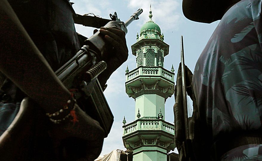 India's Rapid Action Force soldiers patrol in front of a mosque in Mumbai, India, Thursday, Sept. 30, 2010. An Indian court ruled Thursday that a disputed holy site in Ayodhya that has sparked bloody communal riots across the country in the past should be divided between the Hindu and Muslim communities, a lawyer involved in the suit said. The Muslim community said it would appeal the ruling in the 60-year-old case to the Supreme Court. Muslims revere the compound in Ayodhya as the site of the now-demolished 16th century Babri Mosque, while Hindus say it is the birthplace of the god Rama. (AP Photo/Rajanish Kakade)