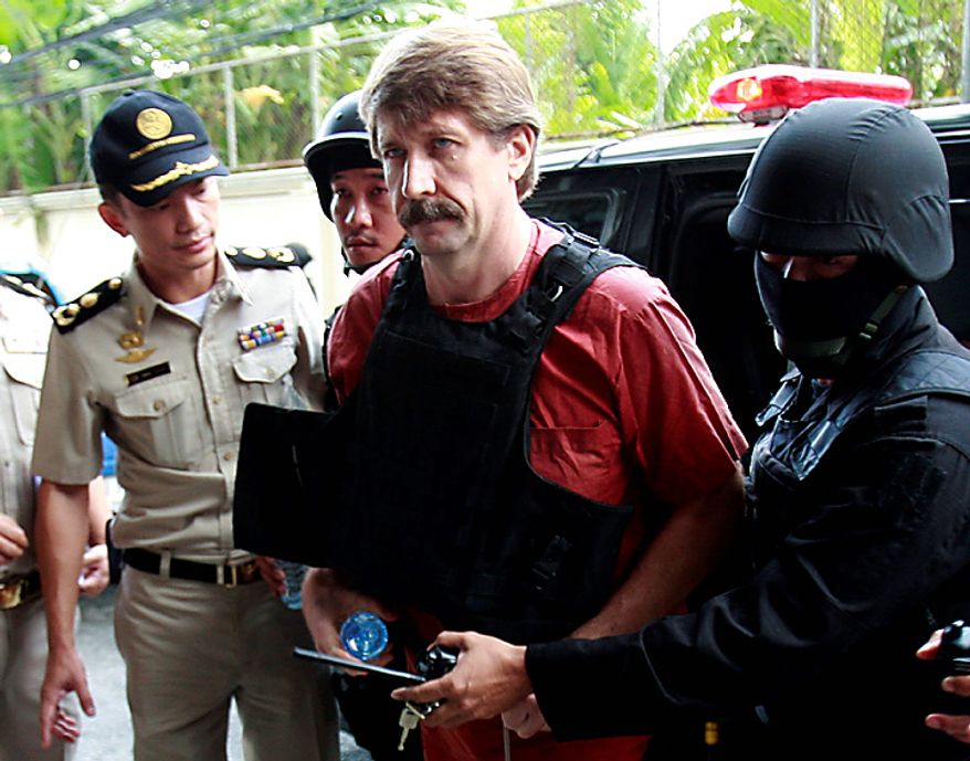 Under heavy security and wearing a bulletproof vest Viktor Bout, center, an alleged Russian arms smuggler, arrives Monday, Oct. 4, 2010, at a Bangkok criminal court for a crucial hearing that could finally determine if he will be extradited to the United States. (AP Photo/Apichart Weerawong)