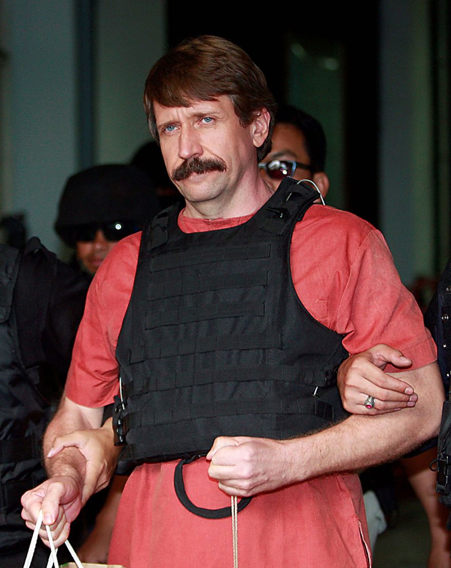 With tight security and the flak jacket on, Viktor Bout, center, a suspected Russian arms dealer, leaves the criminal court in Bangkok, Thailand Monday, Oct. 4, 2010. The Thai court dismissed a request to drop new charges against Bout, a move that means more delays to his long-awaited extradition to the United States. (AP Photo/Apichart Weerawong)