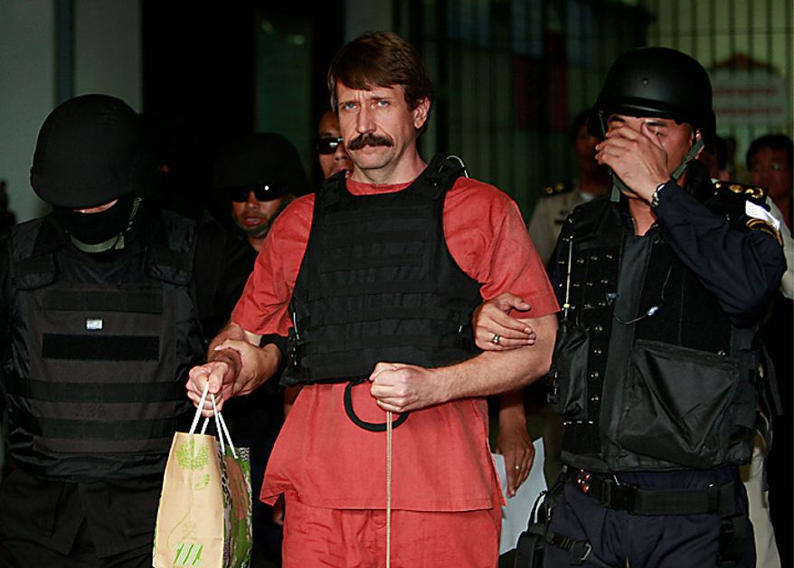 With tight security and the flak jacket on, Viktor Bout, center, a suspected Russian arms dealer, leaves the criminal court in Bangkok, Thailand Monday, Oct. 4, 2010. The Thai court dismissed a request to drop new charges against Bout, a move that means more delays to his long-awaited extradition to the United States. (AP Photo/Apichart Weerawong)