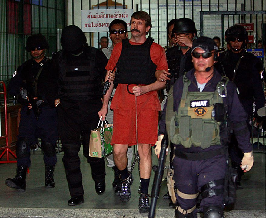 With tight security and the flak jacket on, Viktor Bout, center, a suspected Russian arms dealer, leaves the criminal court in Bangkok, Thailand Monday, Oct. 4, 2010. The Thai court dismissed a request to drop new charges against Bout, a move that means more delays to his long-awaited extradition to the United States. (AP Photo/Apichart Weerawong)