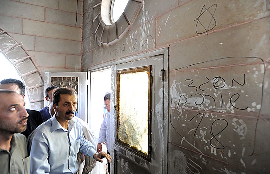 Palestinians look at Hebrew graffiti, that reads 'Mosque toilet 18', with a Star of David in the torched and vandalized Prophet's Mosque in Beit Fajjar, north of Hebron in the West Bank, October 4, 2010, 2010. Palestinian sources said that Jewish settlers entered the mosque and torched the mosque, Koran books, prayer rugs and left Hebrew graffiti with slogans against Arabs, Muslims and Mohammad on the walls. UPI/Debbie Hill