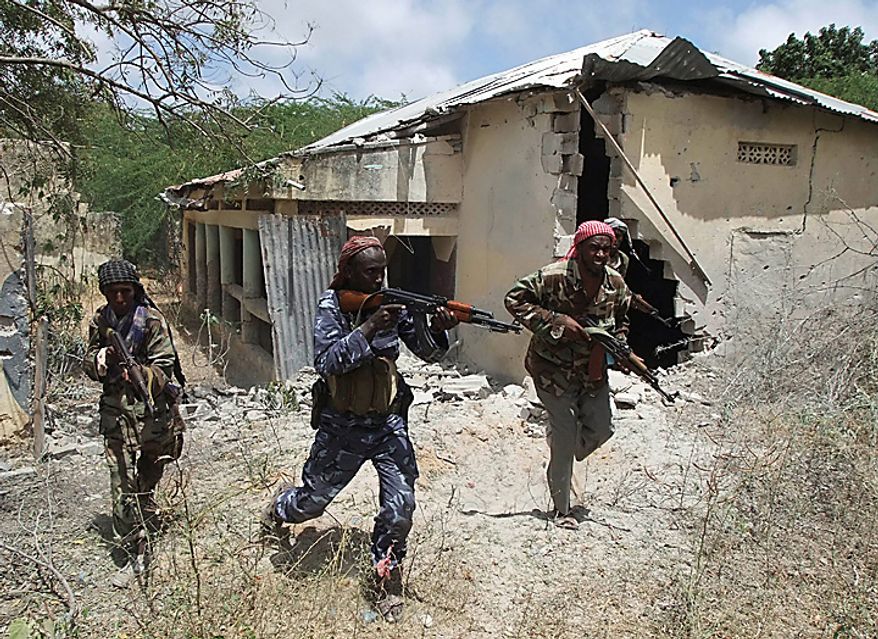 Islamist fighters take positions during clashes with Somali government soldier and African union peacekeepers in southern Mogadishu's Hodon neighborhood, Somalia, Monday Oct. 4, 2010. Ali Muse, the head of Mogadishu's ambulance service, says a spike in violence the last three days in Mogadishu has killed at least 20 civilians. More than 70 people have been wounded. (AP Photo/Farah Abdi Warsameh)