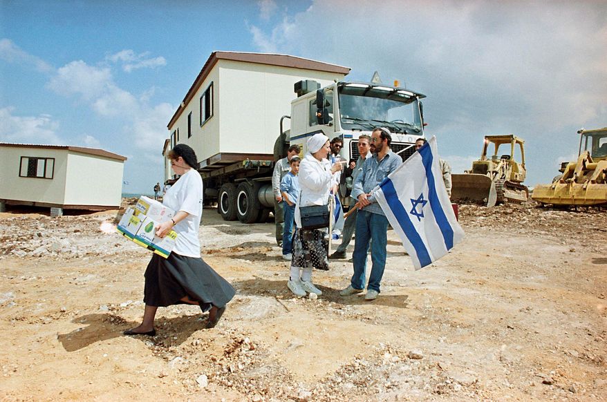 THEN: On April 16, 1991, Jewish settlers establish themselves in Revava, near the West Bank city of Nablus. Nearly two decades ago, when Revava was established, the U.S. was trying hard to push Israelis and Palestinians toward a peace agreement. (Associated Press)