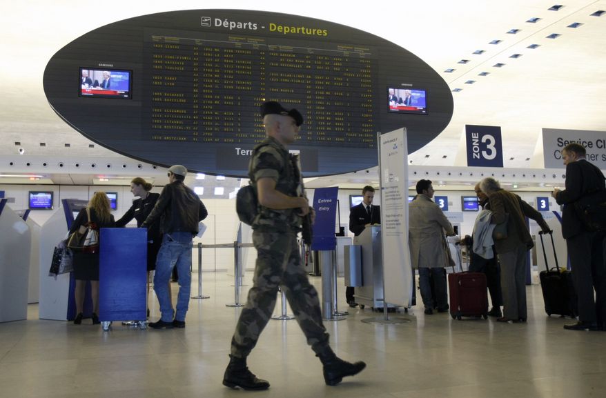 ** FILE ** A French soldier patrols a terminal at Paris' Charles de Gaulle Airport on Monday, Oct. 4, 2010. (AP Photo/Remy de la Mauviniere)
