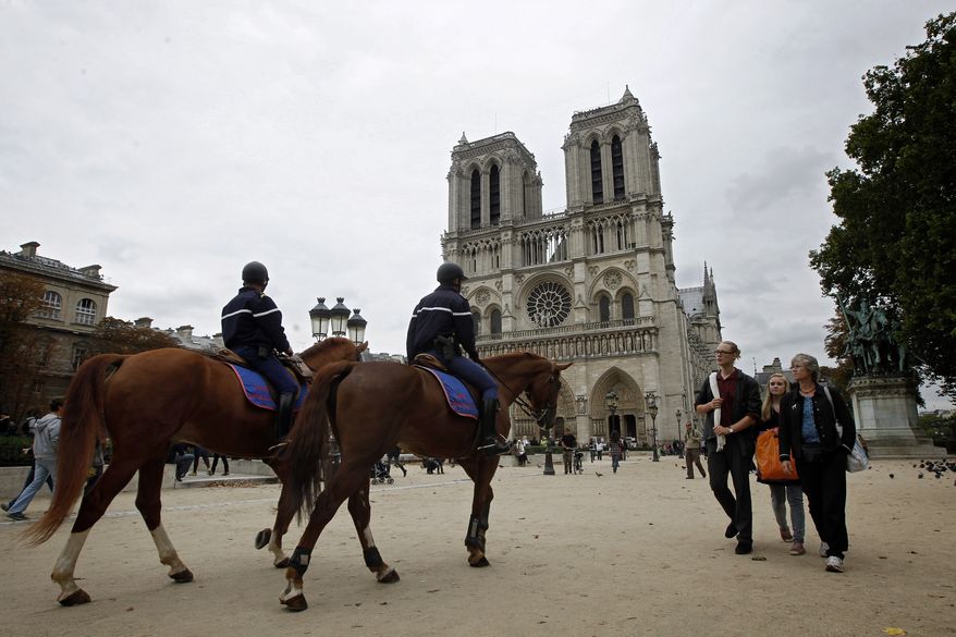 Mounted police patrol outside Notre-Dame Cathedral in Paris on Monday, Oct. 4, 2010. Japan issued a travel alert for Europe on Monday, joining the United States, Sweden and Britain in warning of a possible terrorist attack by al Qaeda or other militant groups, but tourists appeared to be taking the mounting warnings in stride. (AP Photo/Laurent Cipriani)