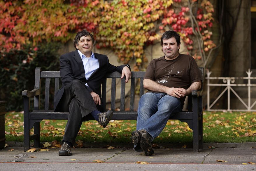 University of Manchester professors Andre Geim and Konstantin Novoselov, right, awarded the Nobel Prize for Physics pose for pictures outside Manchester University, Manchester, England, Tuesday, Oct. 5, 2010. (AP Photo/Jon Super).