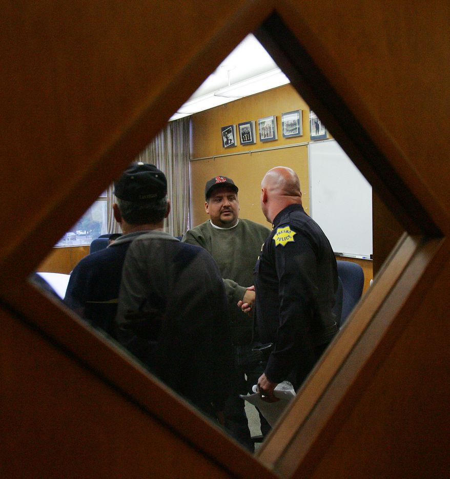 Victor Perez, center, shakes hands with Fresno Police Chief Jerry Dyer Tuesday, Oct 5, 2010, in Fresno, Calif. An 8-year-old girl who was abducted by a stranger while playing outside a Fresno home escaped from her captor after Mr. Perez recognized the suspects vehicle and cut it off, forcing it to stop, police said. The suspect pushed the girl out of the car, and she ran to safety. (AP Photo/Gary Kazanjian)