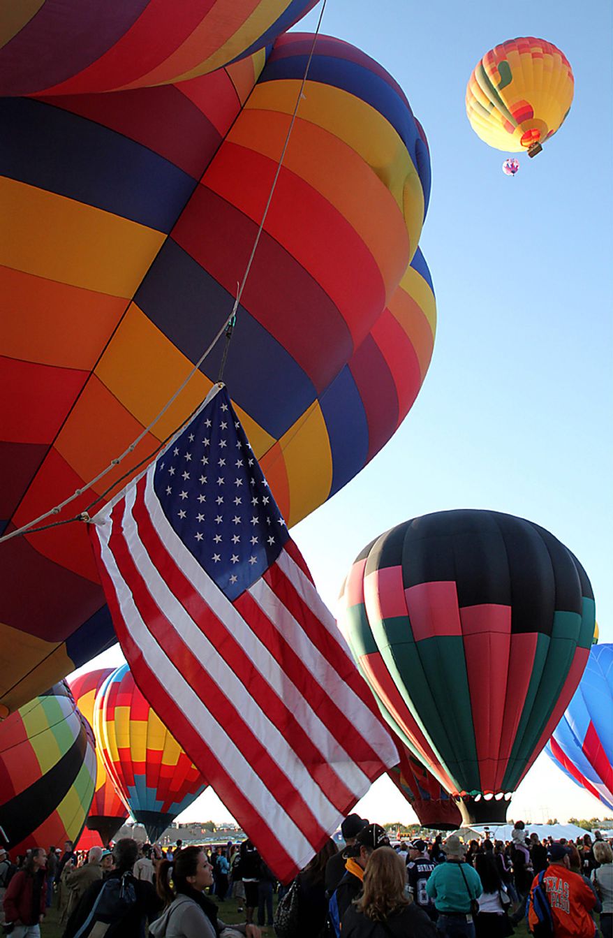 Hot air balloons inflate during the Albuquerque International Balloon Fiesta in Albuquerque, N.M., on Saturday, Oct. 2, 2010. Many balloonists participating in the event are hopeful that missing American pilots Richard Abruzzo and Carol Rymer Davis will be found. The pair went missing over the Adriatic Sea on Wednesday during a European gas balloon race. (AP Photo/Susan Montoya Bryan)