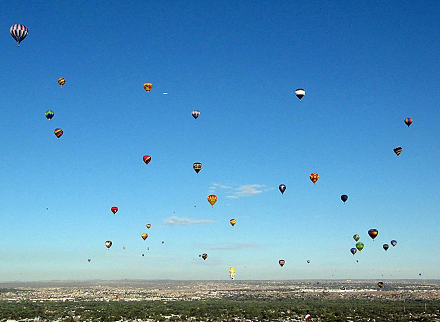 Hot air balloons lift off during the Albuquerque International Balloon Fiesta in Albuquerque, N.M., on Tuesday, Oct. 5, 2010. The annual event has attracted about 500 balloons and thousands of spectators. (AP Photo/Susan Montoya Bryan)