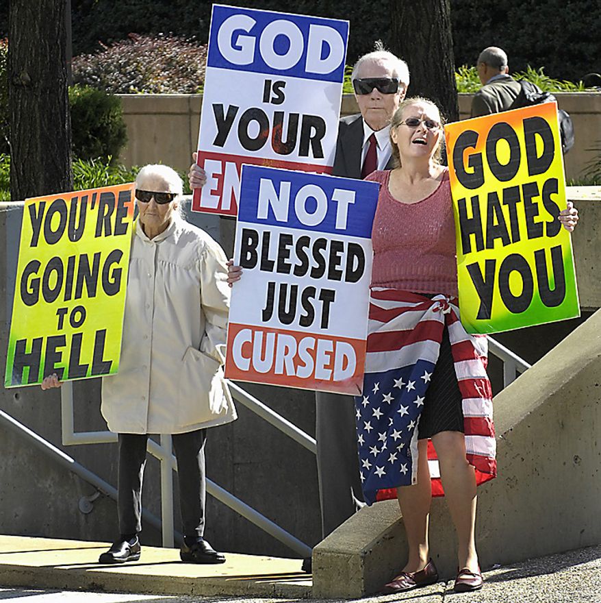 In this Oct. 31, 2007 file photo, Margie M. Phelps, left, stands with her husband Pastor Fred Phelps and her daughter Margie J. Phelps during a demonstration outside the federal courthouse in Baltimore. Margie J. Phelps is set to go before the U.S. Supreme Court on Wednesday, Oct. 5, 2010, to represent her church in a case that tests the scope of free speech protections under the Constitution's First Amendment. (AP Photo/Baltimore Sun, Jed Kirschbaum)