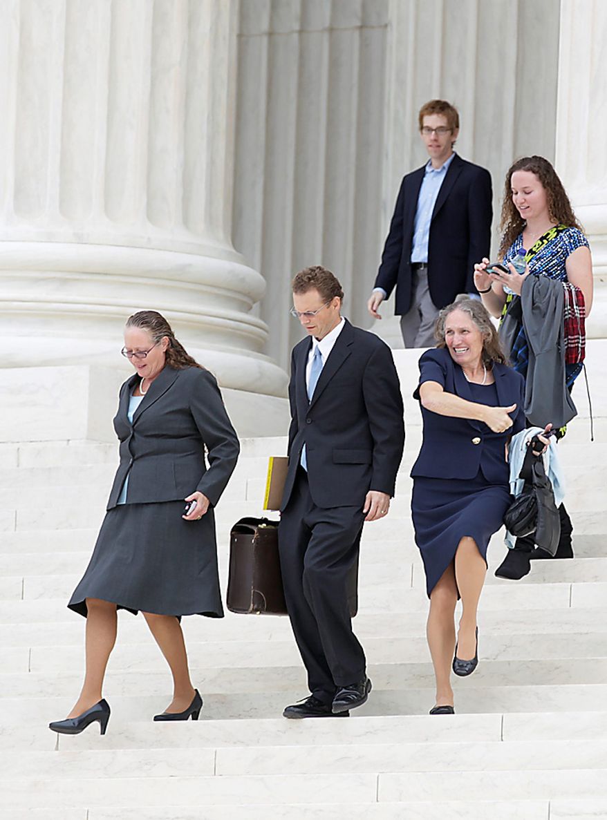 Shirley Phelps-Roper of the Westboro Baptist Church, of Tokepa Kan., lower right, celebrates as she walks down the steps of the Supreme Court in Washington, Wednesday, Oct. 6, 2010,with Margie Phelps, left, the lawyer  and church member who argued the case for the Westboro Baptist Church, after the court heard arguments in the dispute between Albert Snyder, of York, Pa., and the Westboro Baptist Church.  (AP Photo/Carolyn Kaster)