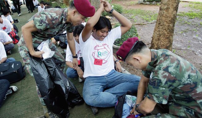 Soldiers search camp arrivals for weapons. Gang violence is deeply entrenched in Bangkok, especially in trade schools, where machetes, homemade bombs and cheap guns are weapons of choice. (Associated Press)