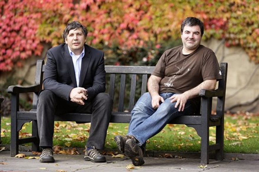 Professor Andre Geim, right, is congratulated by a wellwisher outside Manchester University after being awarded the Nobel Prize for Physics along with colleague Dr Konstantin Novoselov, Manchester, England, Tuesday, Oct. 5, 2010. The scientists shared the Nobel Prize in physics on Tuesday for "groundbreaking experiments" with the thinnest, strongest material known to mankind a carbon vital for the creation of faster computers and transparent touch screens. (AP Photo/Jon Super).
