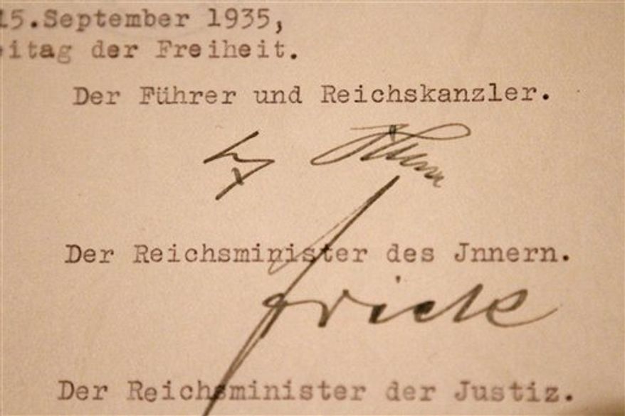 The original Nuremberg Laws, on display at the National Archives in Washington, Wednesday, Oct. 6, 2010. The laws signed by Adolf Hitler took away the citizenship of German Jews before the execution of 6 million Jews during the Holocaust. They will be on exhibit Oct. 6-18, 2010. (AP Photo/Jacquelyn Martin)