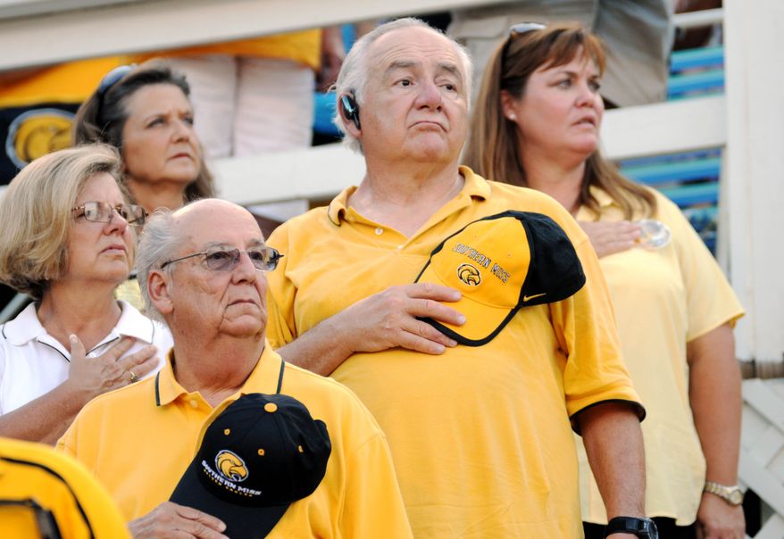 Southern Mississippi fans stand for the pledge of allegiance during the pre-game activities of a NCAA college football game Saturday, Sept. 11, 2010 in Hattiesburg, Miss. against Prairie View. (AP Photo/Steve Coleman)