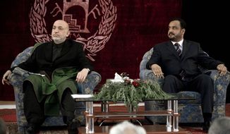 In this photo taken on April 12, 2010, Afghan President Hamid Karzai, left, and Kunduz Gov. Mohammed Omar attend a meeting with elders in Kunduz, Afghanistan. Mr. Omar was among many killed in a bomb blast at a mosque in Takhar province Friday, Oct. 8, 2010. (AP Photo/Dusan Vranic)