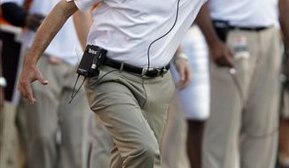FILE - In this Oct. 2, 2010, file photo, Tennessee head coach Derek Dooley reacts on the sideline during the second half of an NCAA college football game against LSU in Baton Rouge, La. Dooley grew up cheering for his father&#39;s team, the Georgia Bulldogs. On Saturday, he will try to beat them. Not surprisingly, Vince Dooley can&#39;t bear to watch, opting to stay at home when his son leads Tennessee against the Bulldogs in a matchup of teams desperate for a win.  (AP Photo/Patrick Semansky, File)