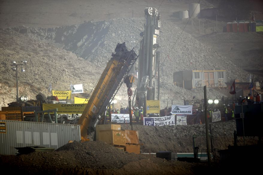 The T-130 drill is seen as a siren goes off announcing that the drill reached the trapped miners in the San Jose mine near Copiapo, Chile, on Saturday, Oct. 9, 2010. (AP Photo/Natacha Pisarenko)