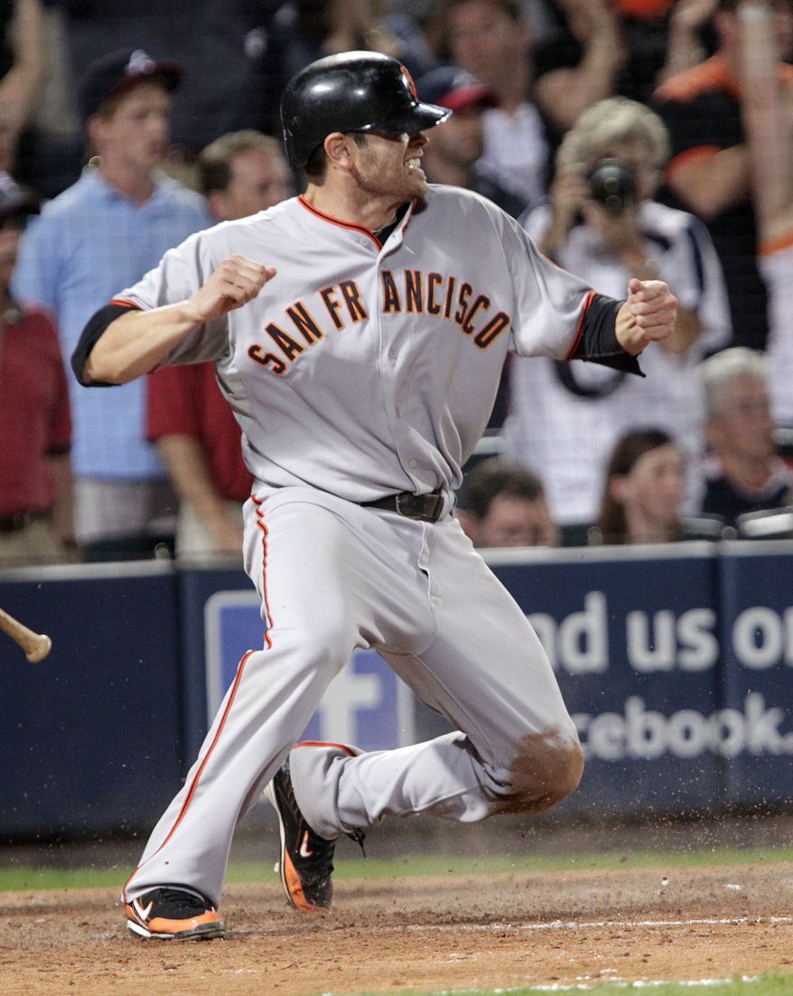 ASSOCIATED PRESS San Francisco Giants' Freddy Sanchez reacts after sliding into home with the go-ahead run on a ball hit by Buster Posey in the ninth inning against the Atlanta Braves in Game 3 of baseball's National League Division Series on Sunday, Oct. 10, 2010, in Atlanta. Braves second baseman Brooks Conrad was charged with an error on the play. The Giants won 3-2.