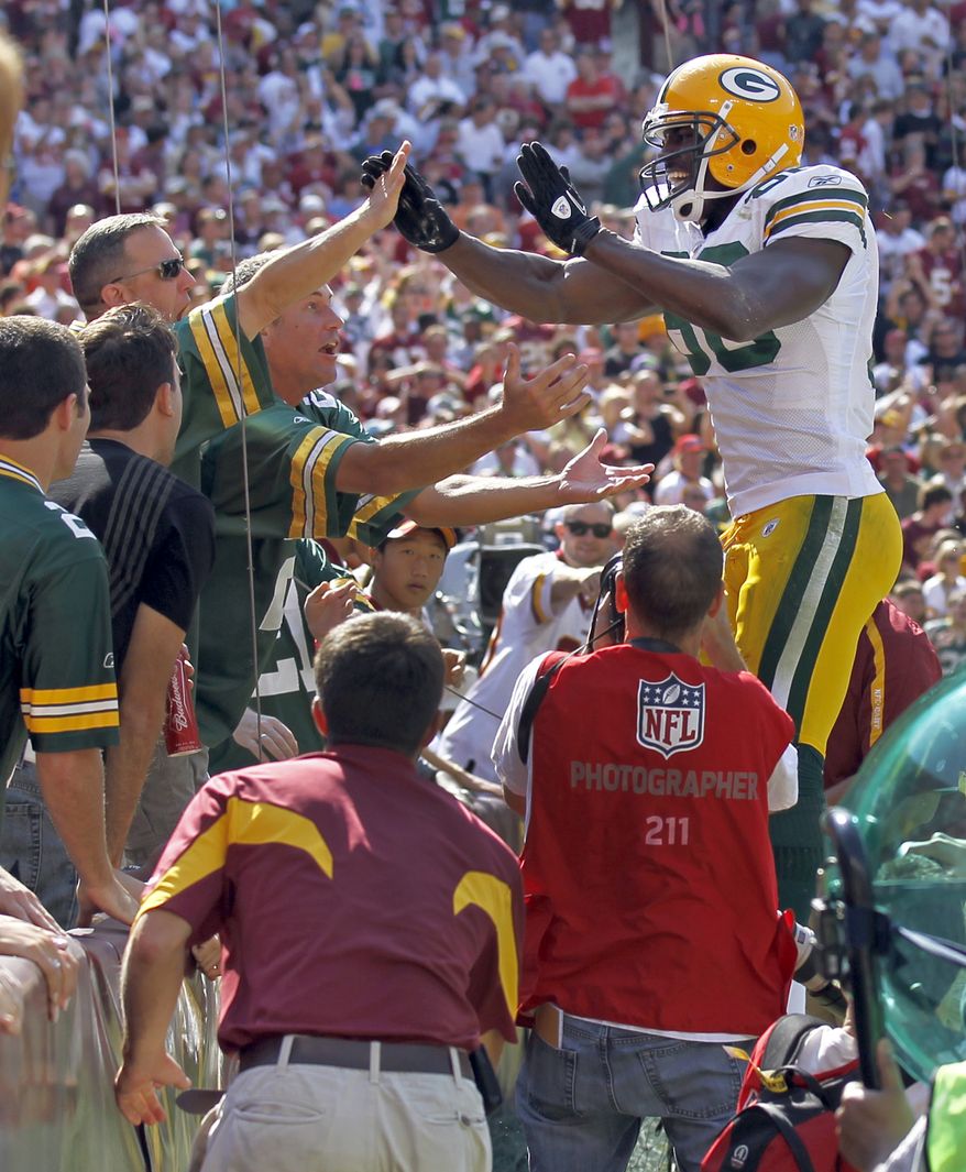 ASSOCIATED PRESS Green Bay Packers tight end Donald Lee celebrates his touchdown with fans during the first half of an NFL football game against the Washington Redskins in Landover, Md., Sunday, Oct. 10, 2010.
