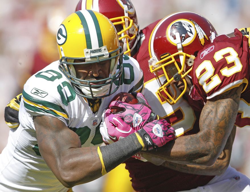 ASSOCIATED PRESS Green Bay Packers tight end Donald Lee, left, pushes across the goal line to score a touchdown under pressure from Washington Redskins cornerback DeAngelo Hall during the first half of an NFL football game in Landover, Md., Sunday, Oct. 10, 2010.