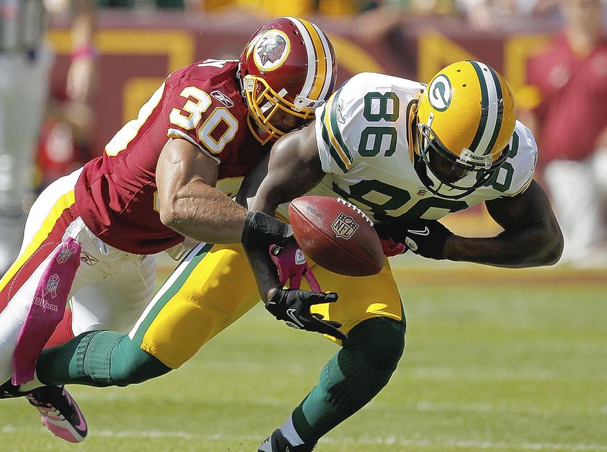 ASSOCIATED PRESS Washington Redskins safety LaRon Landry forces a fumble from Green Bay Packers tight end Donald Lee during the first half of an NFL football game in Landover, Md., Sunday, Oct. 10, 2010. Washington recovered the fumble.