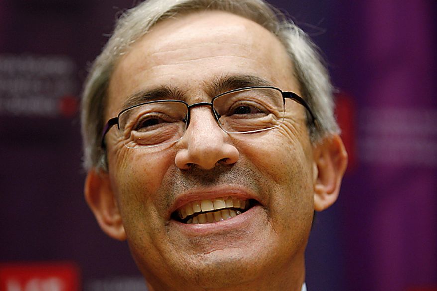 Professor Christopher Pissarides of the London School of Economics smiles as he speaks to the media in London Monday, Oct. 11, 2010, following his joint award for the Nobel Prize in Economic Sciences 2010. The Nobel is awarded jointly to Americans Peter Diamond and Dale Mortensen, and British Cypriot Christopher Pissarides, as joint winners for developing theories that help explain how economic policies can affect unemployment.(AP Photo/Sang Tan)