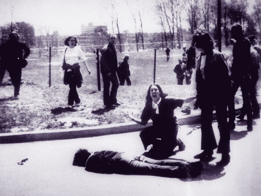 ** FILE ** Mary Ann Vecchio gestures and screams as she kneels by the body of a student lying face down on the campus of Kent State University in Kent, Ohio, on May 4, 1970. (AP Photo/John Filo)