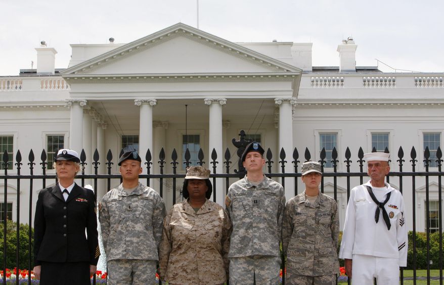 From left, Petty Officer Autumn Sandeen, Lt. Dan Choi, Cpl. Evelyn Thomas, Capt. Jim Pietrangelo II, Cadet Mara Boyd and Petty Officer Larry Whitt stand together on April 16 after they handcuffed themselves to the fence outside the White House during a protest for gay rights. A federal judge issued a worldwide injunction Tuesday stopping enforcement of the "don't ask, don't tell" policy, halting the military's 17-year-old ban on openly gay troops. (Associated Press)