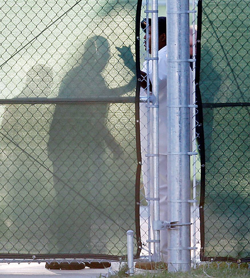 An unidentified man is checked by military personnel behind a security fence at the U.S. Magistrate court where an Article 32 hearing for Maj. Nidal Malik Hasan is scheduled to be held, Tuesday, Oct. 12, 2010, in Fort Hood, Texas. Hasan, 40, is charged with premeditated murder and attempted premeditated murder in a Nov. 5 attack , which killed 13 people and wounded 32 others in a processing center where soldiers were making final preparations to deploy. The Article 32 hearing will determine whether there is enough evidence to put the Army psychiatrist on trial. (AP Photo/Eric Gay)
