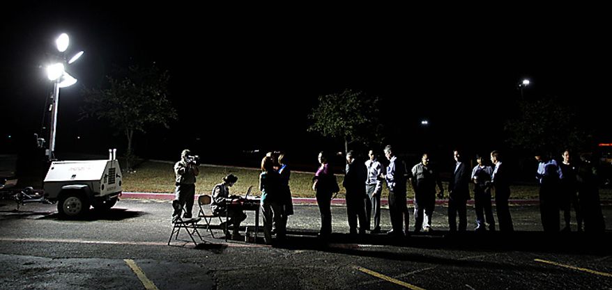 Members of the media check in for an Article 32 hearing for Maj. Nidal Malik Hasan, Tuesday, Oct. 12, 2010 in Fort Hood, Texas. Hasan, 40, is charged with premeditated murder and attempted premeditated murder in a Nov. 5 attack , which killed 13 people and wounded 32 others in a processing center where soldiers were making final preparations to deploy. The Article 32 hearing will determine whether there is enough evidence to put the Army psychiatrist on trial. (AP Photo/Eric Gay)