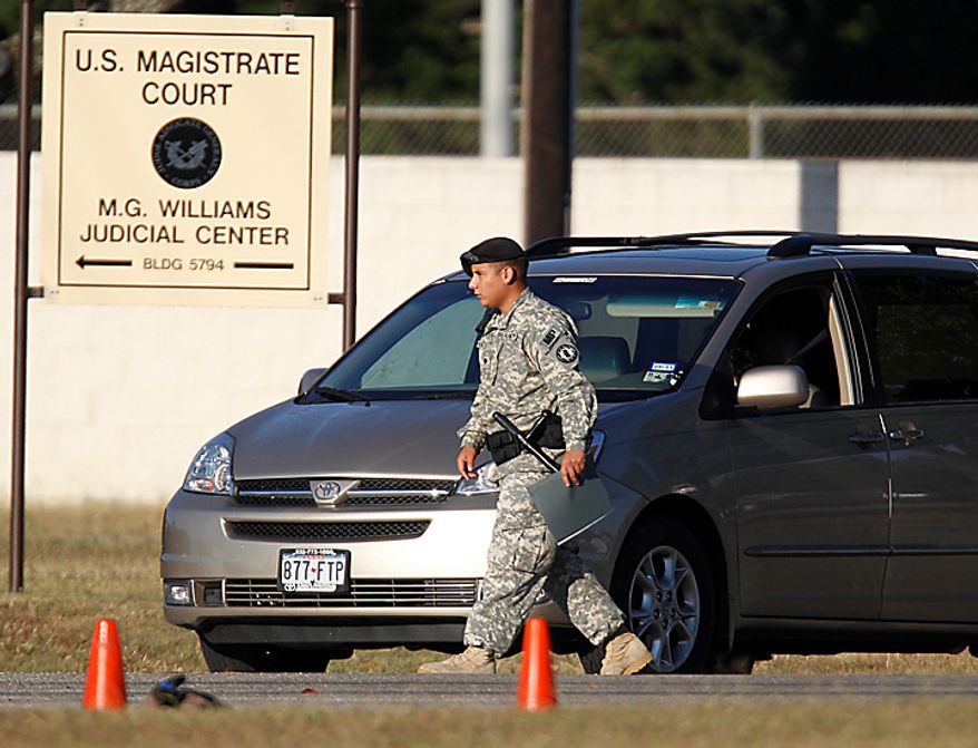 Military police check a vehicle outside the U.S. Magistrate court where an Article 32 hearing for Maj. Nidal Malik Hasan is scheduled to be held, Tuesday, Oct. 12, 2010 in Fort Hood, Texas. Hasan, 40, is charged with premeditated murder and attempted premeditated murder in a Nov. 5 attack , which killed 13 people and wounded 32 others in a processing center where soldiers were making final preparations to deploy. The Article 32 hearing will determine whether there is enough evidence to put the Army psychiatrist on trial. (AP Photo/Eric Gay)