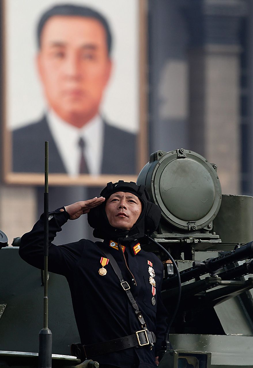 A North Korean soldier salutes during a massive military parade marking the 65th anniversary of the communist nation's ruling Workers' Party in Pyongyang, North Korea on Sunday, Oct. 10, 2010. This year's celebration comes less than two weeks after Kim Jong Il's re-election to the party's top post and the news that his 20-something son would succeed his father and grandfather as leader. (AP Photo/Vincent Yu)